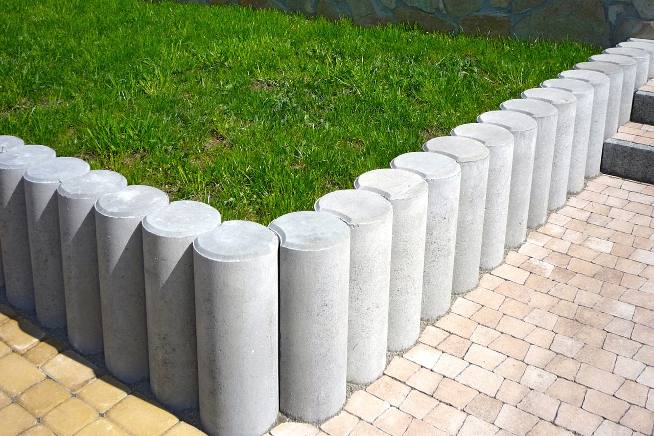 our-services-1 Cylindrical concrete blocks form a stylish lawn boundary, enhancing garden aesthetics.
